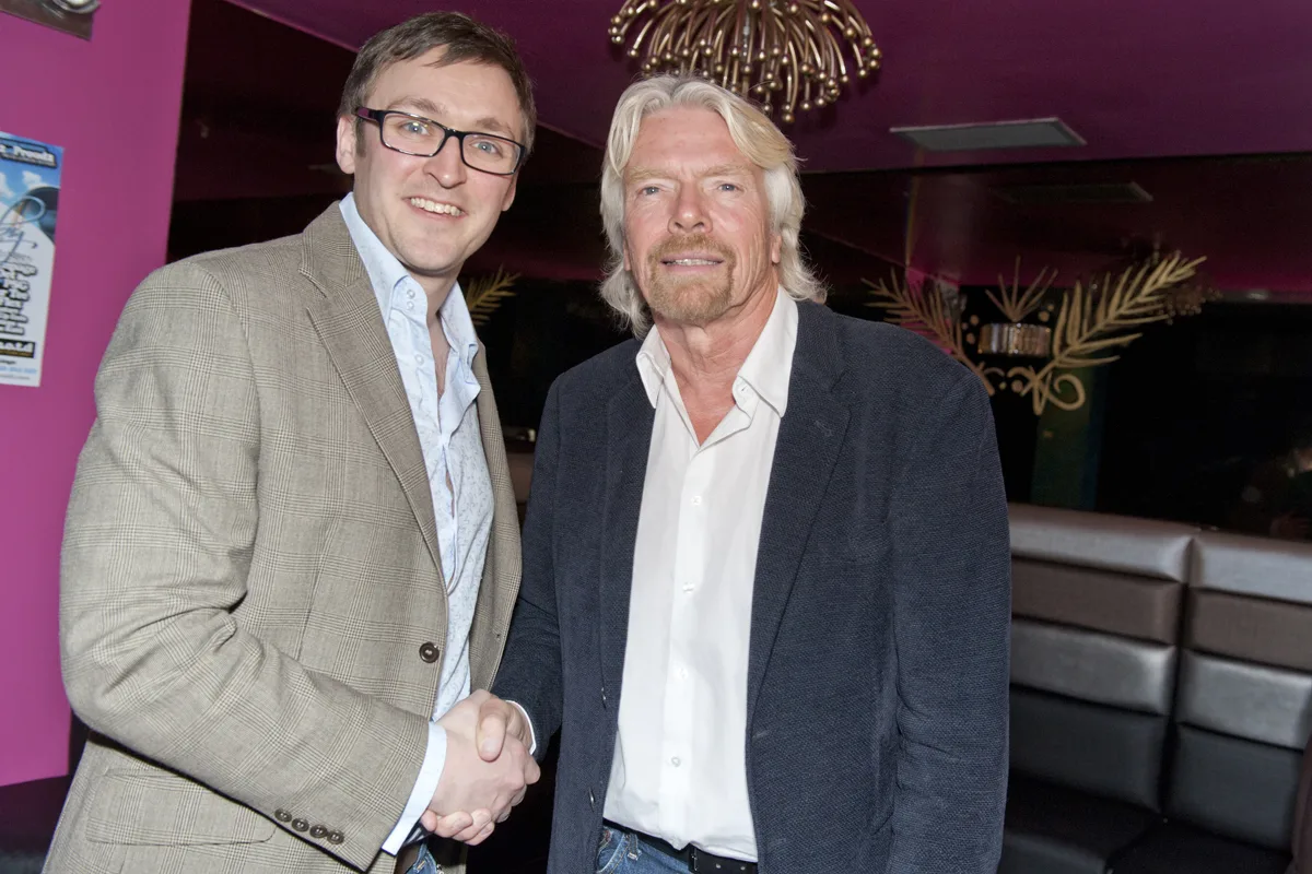 Paul shaking hands with Richard Branson.